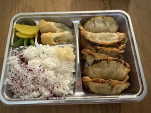 Age (fried) gyoza bento. Spaghetti noodles and potatoes are under the gyoza  at KAMINARI GYOZA in Los Angeles