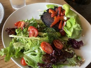 Portobello burger on lettuce with side salad  at Vegan & Vine in Phoenix