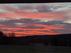 Watch the sunrise over the bluffs from the front porch at Ugly Biscuits Bed and Breakfast in Baraboo