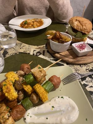 Skewers in the front, classic burger and ravioli   at Origami in La Spezia