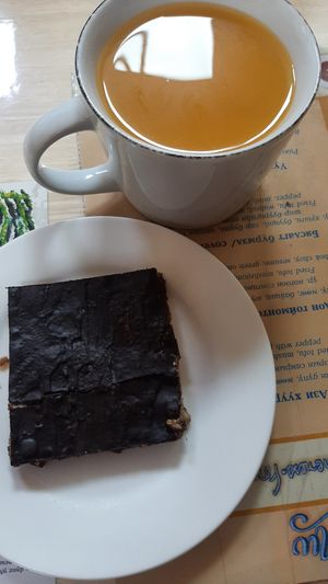 Vegan gluten-free caramel slice; Hot seabuckthorn juice at The Oneness Fountain Heart Vegan/Vegetarian Cafe in Ulaanbaatar