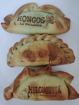 Three vegan empanadas with their names stamped on at La Paisanita in Prague