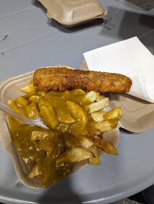 Battered sausage with chips and curry sauce. £7. at The Food Studio @ ChippyLane in Cardiff