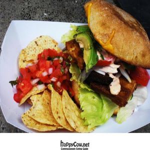 Baked Tofu Sandwich with spicy Veganaise aioli, lettuce, tomatoes, red onions, and avocado on ciabatta. at Dandelion Food Cart in Madison