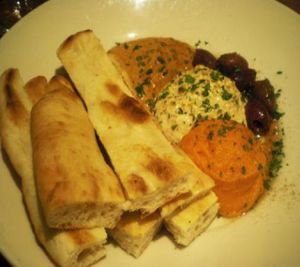 Mediterranean Flat Bread platter: warm Indian flatbread with housemade hummus, muhammara, carrot terche, and kalamata olives. at Dobhan in Madison