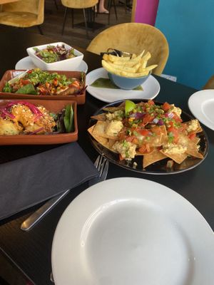 3 sharing plates and sides of salad and seasoned chips   at Jungle Bird in Birmingham