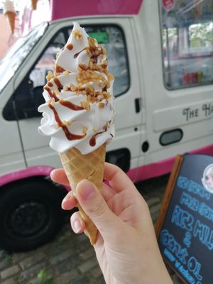 Soft serve ice-cream with caramel sauce with caramel crunch bits in a cone at The Happy Cow in Bristol