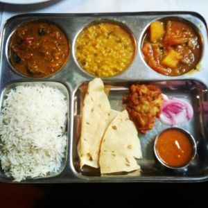 thali, eggplant curry, dal (lentils), vegetable masala, rice, pakora, chutney, papadam and onion at Veggie Garden - Dels Angels in Barcelona