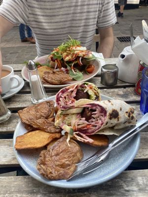 falafel & tahini wrap with potato skins. grilled halloumi on sourdough in background  at Chapters in Durham