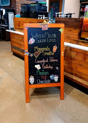 Sandwich board inside at Wild Pony Coffee Co in Evansville