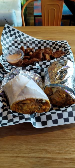 Cali burrito with a side of fried pickles at Never Caged in Los Angeles