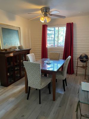 Our dining area includes a table and chairs, a refrigerator, a microwave, and a coffee maker. at Rancho Vegano in Tucson