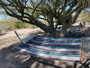 Relax in a hammock ar at a picnic table underneath shady trees. at Rancho Vegano in Tucson