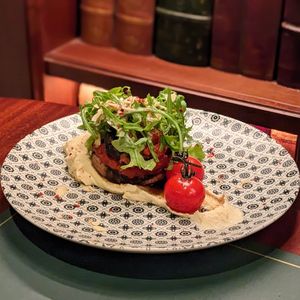 Vegan Whole Roasted Portobello Mushroom with Sun-Dried Tomatoes, Onion, Sumac Spice served with Butterbean Mash at Cultivate Cafe in Central Singapore