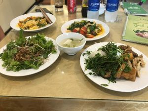 Mushroom and legumes on right. Plate of extra vegetables top right. at Tinh Quan in Hue