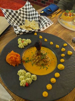 Tandoor 'chicken' on a wooden 'bone' at Késarum in Southampton