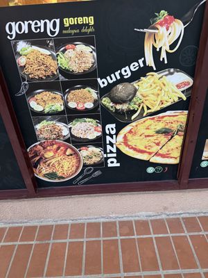 Malay delights, burgers and pizza being promoted outside   at Nadia Vege Cafe in Kuala Lumpur