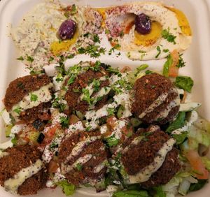 Vegan falafel platter.  Falafel atop salad, with tahini drizzle and sides of hummus and baba ghanouj.  Also comes with pita bread (not pictured).  So good! at Gyro Makers in Renton
