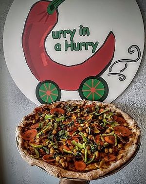 Thin crust hand tossed pizza topped with thai peanut sauce, chicpeas, carrots, green bell peppers, fresh basil and chives. Also comes with a large fountain drink. at Curry in a Hurry in Omaha