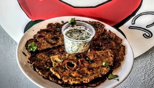 Thalipeeth: Savoury multi-grain flatbread popular in Western India, particularly Maharashtra.  at Curry in a Hurry in Omaha
