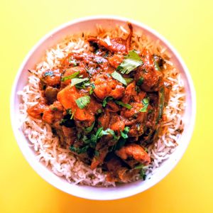 Presenting Veg. Jalfrezi: Mixed veggies stir-fried in a tangy tomato sauce, garnished with cilantro served over long grain basmati saffron rice. at Curry in a Hurry in Omaha