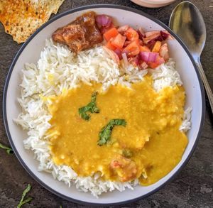 Made with a blend of three healthy lentils - toor dal, moong dal and masoor dal stirred with a tempering of whole Indian spices and ginger. Served over long grain basmati rice.  at Curry in a Hurry in Omaha