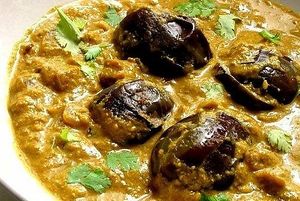 Small eggplants cooked in a flavorful gravy made from peanuts, sesame seeds, coconut, tamarind, and a blend of aromatic spices. The dish typically has a rich, slightly tangy taste  at Curry in a Hurry in Omaha