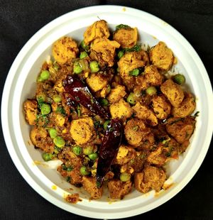 Soy chunk masala is a savory and spicy dish where protein-rich soy chunks are cooked in a thick, flavorful gravy made with onions, green peas, ginger, garlic, and Indian spices at Curry in a Hurry in Omaha
