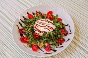 “ Glistrida did you eat? ” (Cool Salad with  Purslane,cherry tomatoes, Cretan seven-leaved rusks, olive slices, yogurt sauce, aromatic with mint olive oil & balsamic cream)  at Kriton Gefsis in Aegina in Aegina