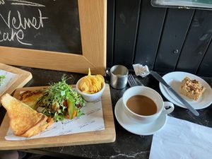 Vegan mozzarella, pesto and sun-dried tomato toastie with oat milk coffee and maple and pecan vegan and gluten free flapjack. Yum at Tyninghame Smithy in Tyninghame