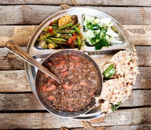 Lunch platter with local organic brown rice, beans, vegetable curry, and salad.  at Sadhana Forest Seva Kitchen in Auroville