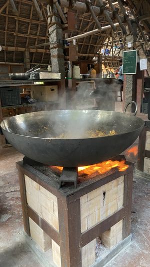 Eco friendly cooking on rocket stoves  at Sadhana Forest Seva Kitchen in Auroville