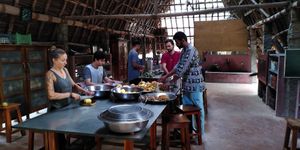 Volunteers help cutting at Sadhana Forest Seva Kitchen in Auroville