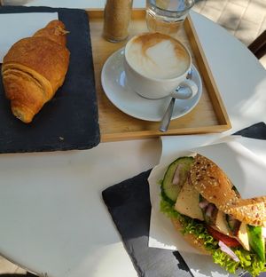 Orange croissaint, oat cappucino and tofu bagel at Robert Capa Café in Budapest
