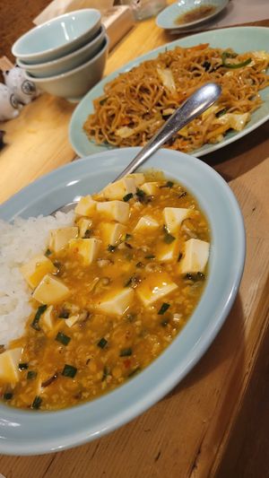 Mapo tofu, Japanese less spicy style. Backround: Yakisoba at Heianraku in Takayama