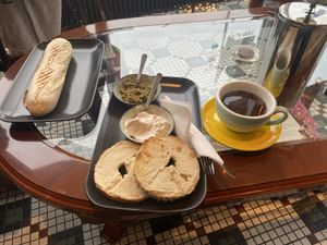 ham and cheese croissant, bagel with pesto and cream cheese, french press coffee  at Valkyrjan Bistro & Bar in Reykjavik