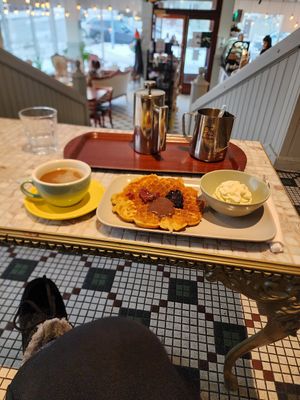 Waffle with vegan cream, jam, and chocolate frosting, and a french press coffee with oat milk at Valkyrjan Bistro & Bar in Reykjavik