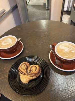 Plant-based cappuccino and café latte with a vegan cinnamon rolll  at OA Coffeeshop in Tallinn