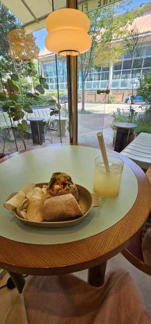 Cafe is on the side of the building, Tofu Wrap and Lemon Ginger Tea   at Cosmos Grocery Cafe in Seoul
