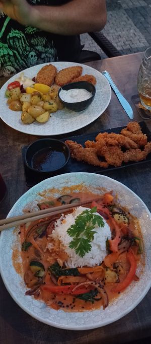 Red thai curry, vegan "calamari" panko oyster mushroom and schnitzels with potatoes and tartare mayo. Amazing! at Vegan House in Prague