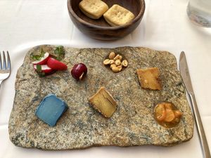 Selection of cheeses with kumquats, radish and marinated cherry  at DaiCa in Mallorca