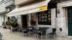 Tables outside and insidee  at Kasthamandap Restaurant And Cafe House in Lisbon
