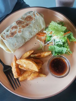 Spicy burrito wrap with wedges and salad at Vegan Tranquil Rose in Kandy