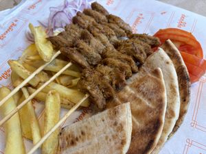 Vegan souvlaki with fries, pita, grilled onion, and fresh tomato. Unfortunately no greens.  at Ladokolla  in Kefalonia