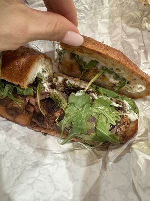 Flores sandwiches on gluten free bun  at Maciel's Plant-Based Butcher & Deli in Los Angeles