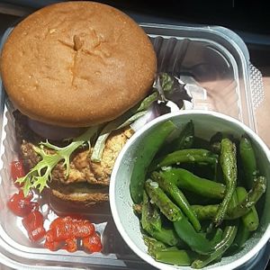 Garden Guardian: housemade gf/v veggie garbanzo bean burger on a gf/v bun w/ greens, zucchini, red onion, roasted red pepper, & balsamic vinaigrette, served w/ garlic green beans at Toast in Lincoln