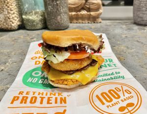 Chik’n bacon ranch burger with onion rings added    at Next Level Burger - West Burnside in Portland