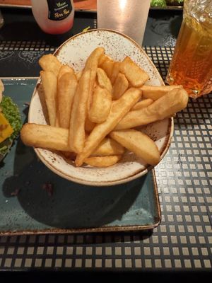 Fries and tasty orange peach ice tea.  at Peter Pane - Neue Promenade in Berlin