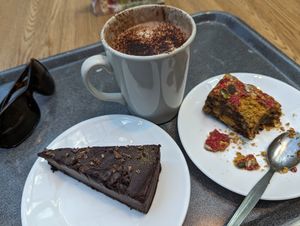 Healthy lunch. Vegan Clementine chocolate torte. Pistachio pomegranate thingy. Hot chocolate. at Levels Café and Lounge in Edinburgh