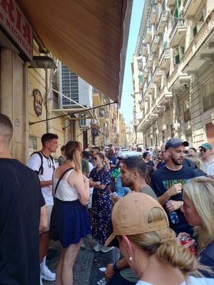 Behind the guy with white t shirt next to the girl with blue skirt is the line for take away at Pizzeria da Michele in Naples
